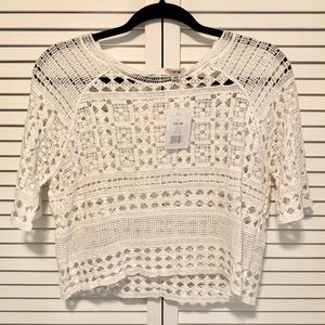 Cropped short sleeve crochet top in white.